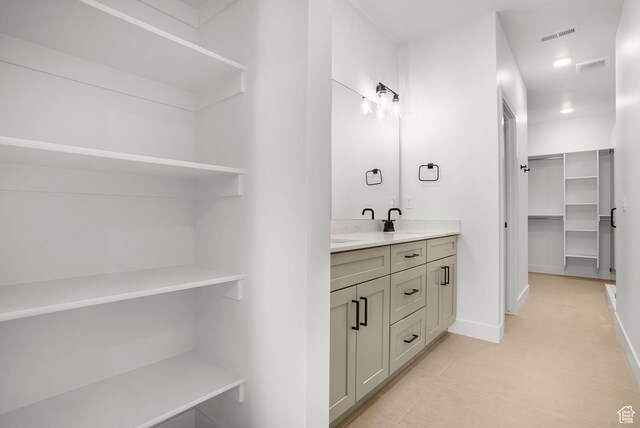 1631 W Century Ln Unit A, Mapleton, UT 84664 - bathroom with double vanity, a walk in closet, and baseboards