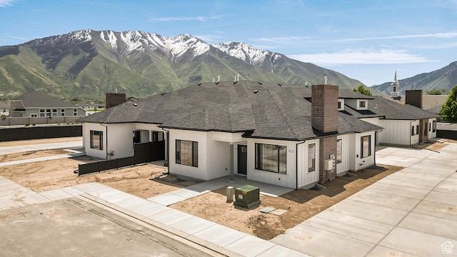 1631 W Century Ln Unit A, Mapleton, UT 84664 - view of front of property featuring a chimney, roof with shingles, a mountain view, and a patio