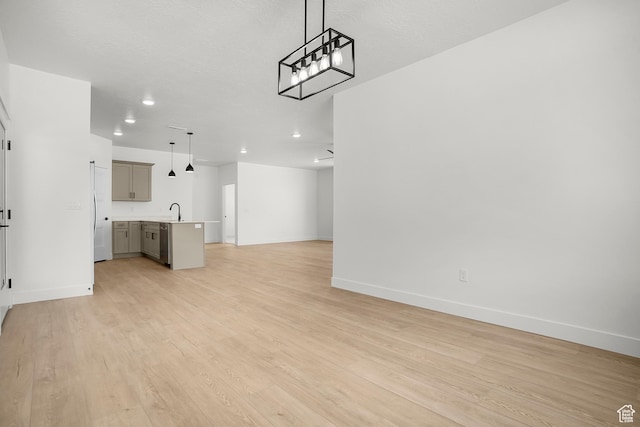 1631 W Century Ln Unit A, Mapleton, UT 84664 - unfurnished living room with baseboards, light wood finished floors, a sink, and recessed lighting