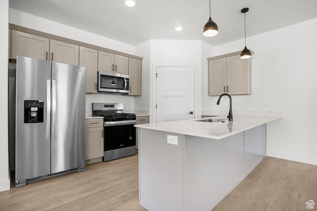 1631 W Century Ln Unit A, Mapleton, UT 84664 - kitchen with appliances with stainless steel finishes, a sink, light wood-style floors, a peninsula, and light countertops