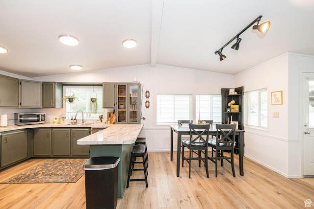 1935 S 1250 W, Logan, UT 84321 - kitchen featuring a breakfast bar area, a sink, light wood-style floors, a peninsula, and gray cabinetry