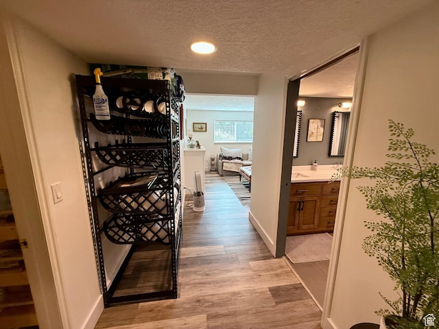1367 N Brookhurst Cir, Centerville, UT 84014 - hall featuring a textured ceiling, light wood-style flooring, recessed lighting, and baseboards
