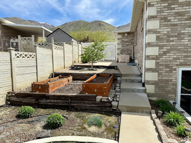 1367 N Brookhurst Cir, Centerville, UT 84014 - view of patio featuring a vegetable garden and a mountain view