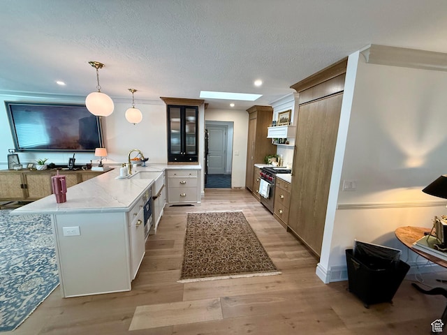 1367 N Brookhurst Cir, Centerville, UT 84014 - kitchen featuring high end range, a peninsula, light wood-type flooring, glass insert cabinets, and decorative light fixtures