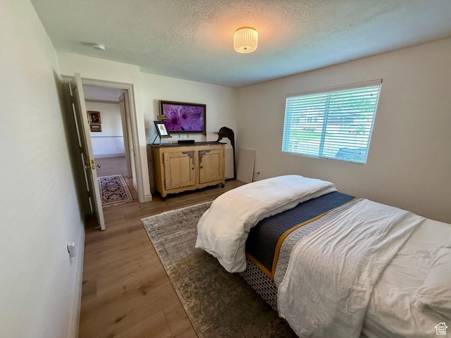 1367 N Brookhurst Cir, Centerville, UT 84014 - bedroom with a textured ceiling and light wood-type flooring