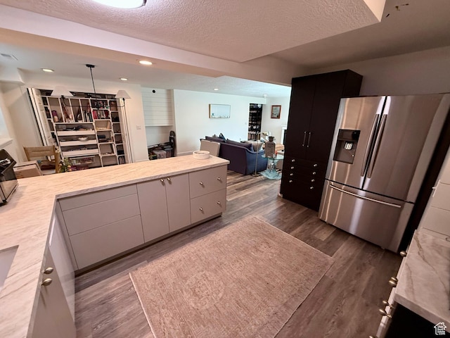 1367 N Brookhurst Cir, Centerville, UT 84014 - kitchen featuring stainless steel fridge with ice dispenser, light countertops, open floor plan, a textured ceiling, and dark wood finished floors