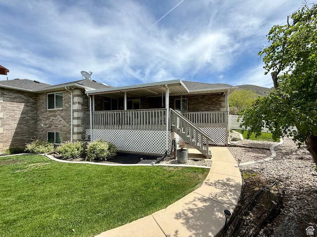 1367 N Brookhurst Cir, Centerville, UT 84014 - view of side of property with brick siding, a yard, and a shingled roof