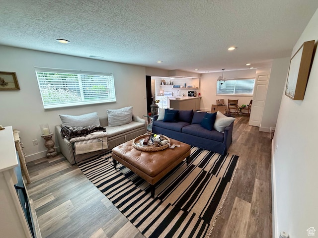 1367 N Brookhurst Cir, Centerville, UT 84014 - living area featuring wood finished floors, recessed lighting, healthy amount of natural light, a textured ceiling, and baseboards