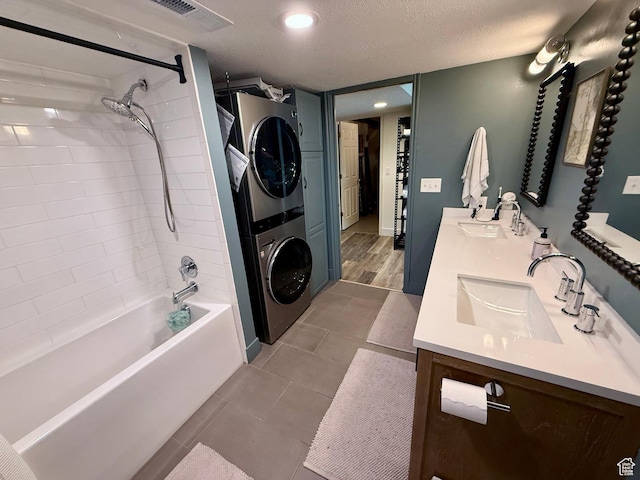 1367 N Brookhurst Cir, Centerville, UT 84014 - bathroom with stacked washer and clothes dryer, double vanity, bathtub / shower combination, and tile patterned floors