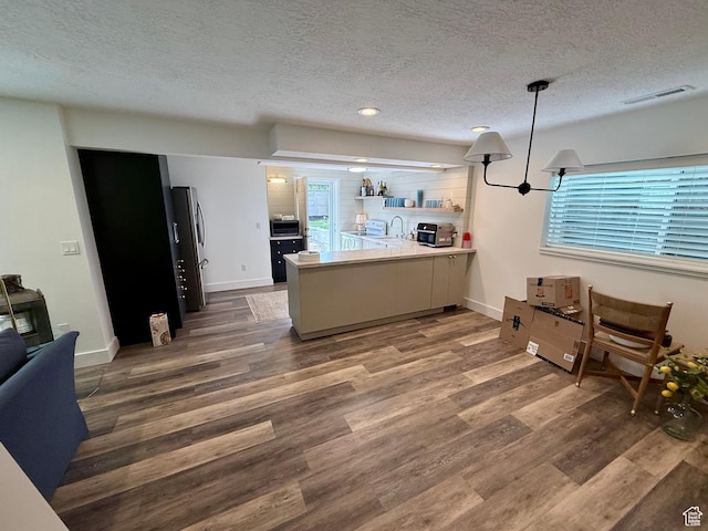 1367 N Brookhurst Cir, Centerville, UT 84014 - kitchen featuring a peninsula, stainless steel appliances, wood finished floors, a textured ceiling, and open shelves
