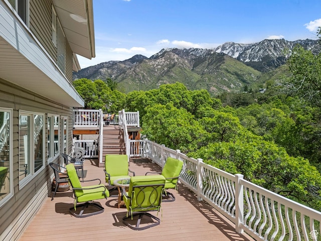 wooden terrace featuring a mountain view and stairway