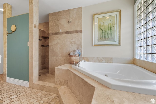 full bathroom with a bath and a walk in shower