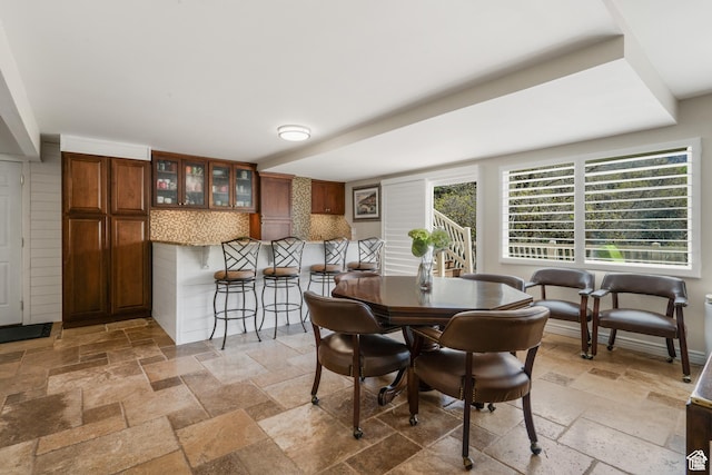 dining space featuring stone tile floors