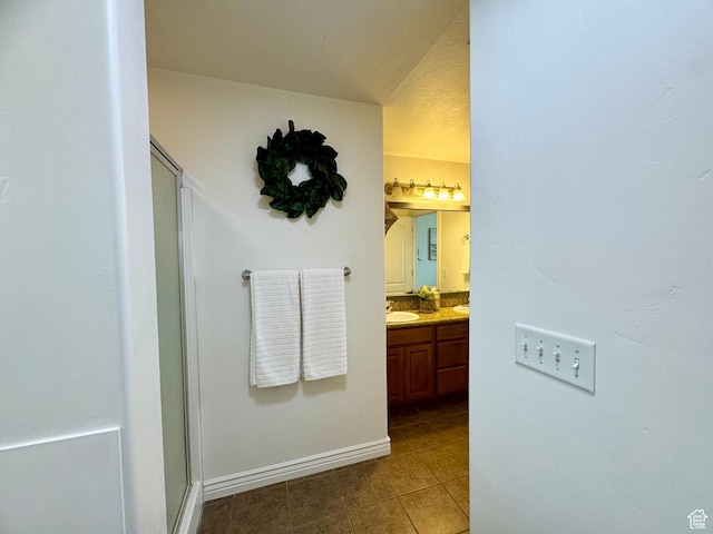 5062 W Valmont Way, Herriman, UT 84096 - full bath with tile patterned floors, a stall shower, vanity, and baseboards