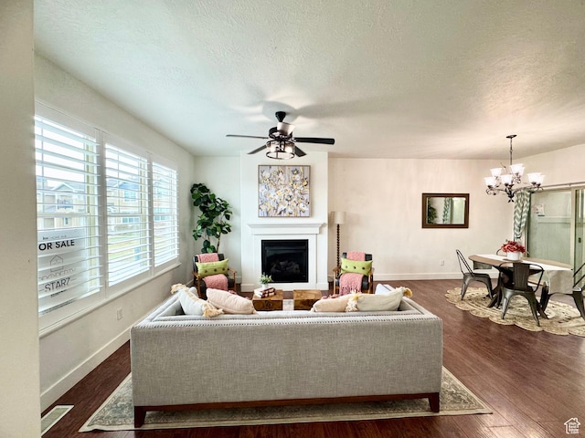 5062 W Valmont Way, Herriman, UT 84096 - living area with a chandelier, a fireplace, a textured ceiling, dark wood-type flooring, and baseboards
