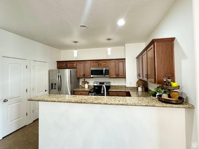 5062 W Valmont Way, Herriman, UT 84096 - kitchen featuring stainless steel appliances, a peninsula, light stone countertops, brown cabinetry, and hanging light fixtures