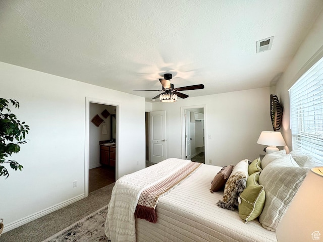 5062 W Valmont Way, Herriman, UT 84096 - carpeted bedroom with baseboards, a ceiling fan, a walk in closet, ensuite bathroom, and a textured ceiling