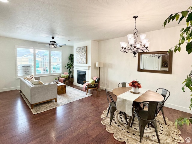 5062 W Valmont Way, Herriman, UT 84096 - dining room with a glass covered fireplace, baseboards, dark wood-type flooring, and a textured ceiling