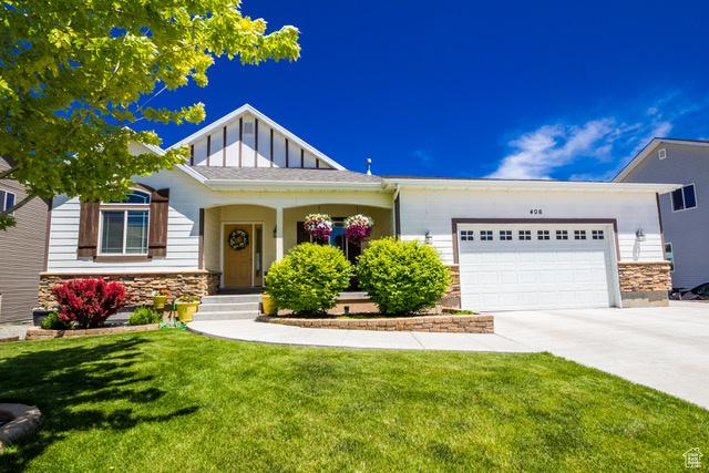 406 W 3775 S, Vernal, UT 84078 - craftsman inspired home featuring stone siding, concrete driveway, an attached garage, a front yard, and board and batten siding