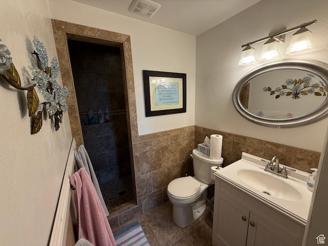 1255 W 200 S, Vernal, UT 84078 - full bathroom with vanity, toilet, tile patterned floors, tiled shower, and wainscoting