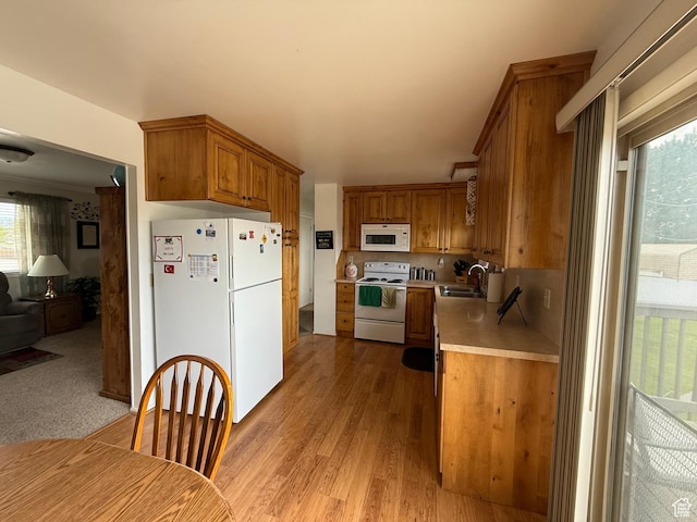 1255 W 200 S, Vernal, UT 84078 - kitchen featuring white appliances, a sink, light countertops, brown cabinets, and light wood finished floors