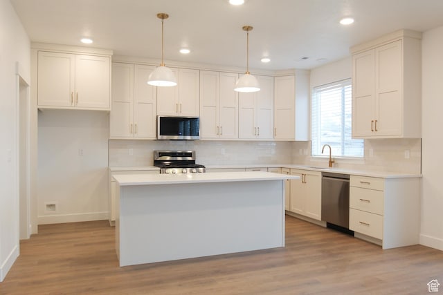 757 E 1250 S, Hyrum, UT 84319 - kitchen featuring appliances with stainless steel finishes, white cabinets, baseboards, tasteful backsplash, and a sink