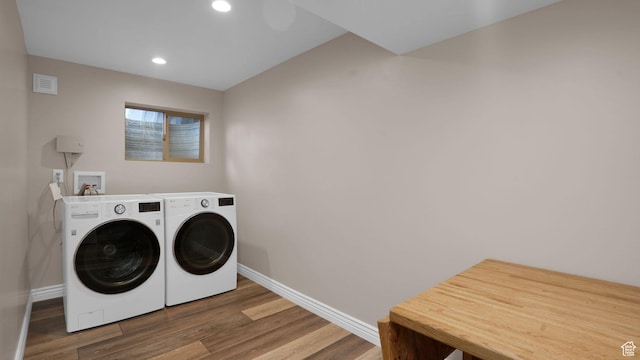 laundry area featuring baseboards, wood finished floors, independent washer and dryer, and recessed lighting