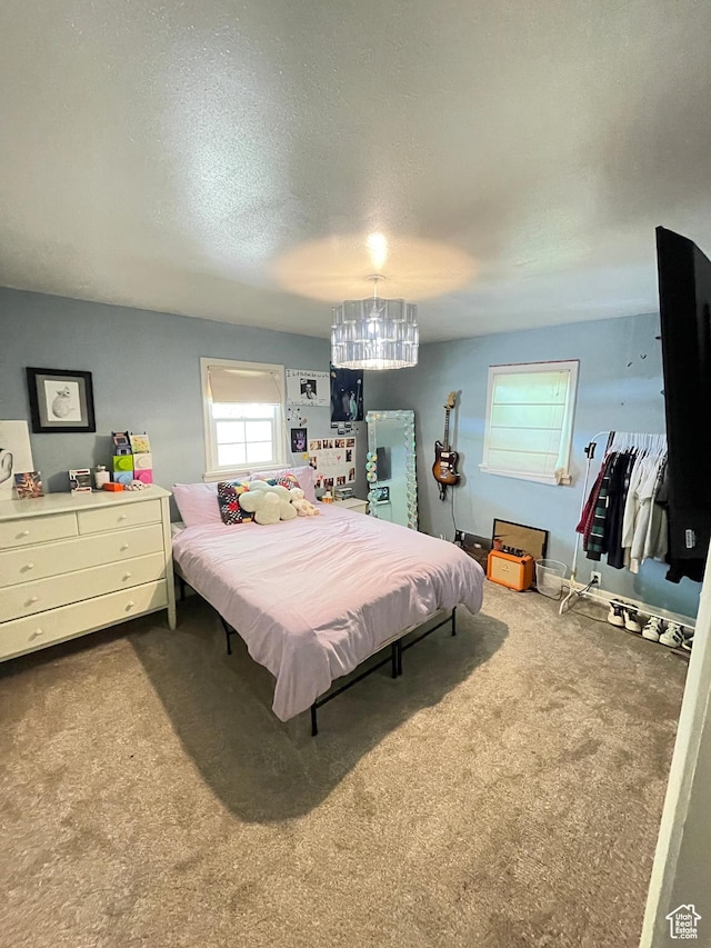 578 S 1500 W, Vernal, UT 84078 - bedroom with carpet floors, a textured ceiling, and a chandelier