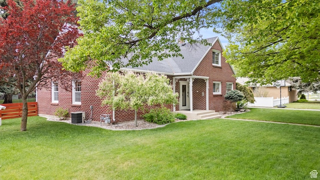 312 E 1st S, Preston, ID 83263 - view of front facade featuring central AC unit, a shingled roof, and brick siding
