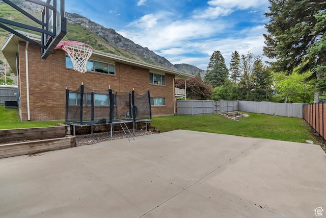 1485 E 1850 N, Provo, UT 84604 - rear view of house featuring a mountain view, a trampoline, a patio area, and brick siding