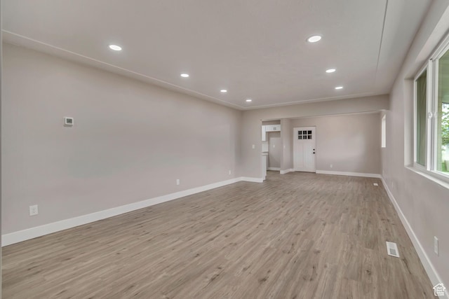 4098 W 5580 S, Salt Lake City, UT 84118 - unfurnished living room with light wood-style flooring, baseboards, and recessed lighting