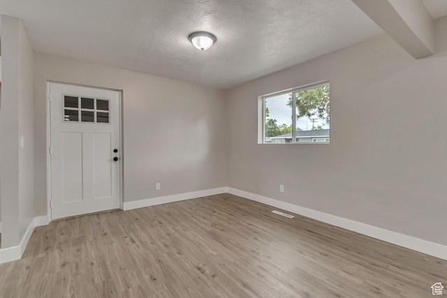 4098 W 5580 S, Salt Lake City, UT 84118 - empty room with light wood-style floors, baseboards, and a textured ceiling