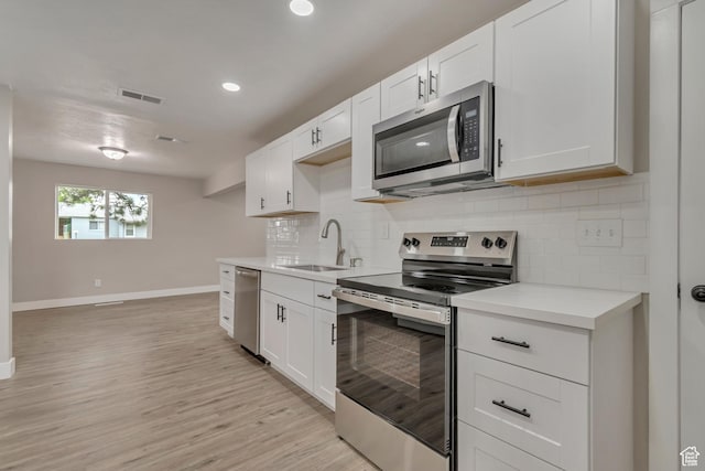4098 W 5580 S, Salt Lake City, UT 84118 - kitchen with stainless steel appliances, a sink, baseboards, light countertops, and tasteful backsplash