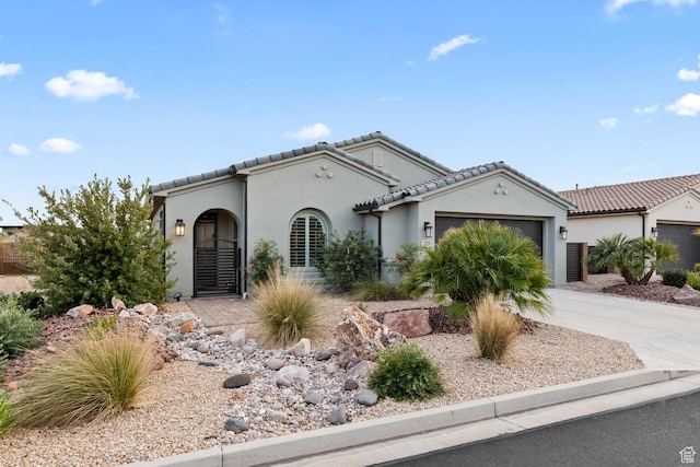 225 W Peridot Dr, Washington, UT 84780 - mediterranean / spanish home with an attached garage, stucco siding, concrete driveway, and a tiled roof