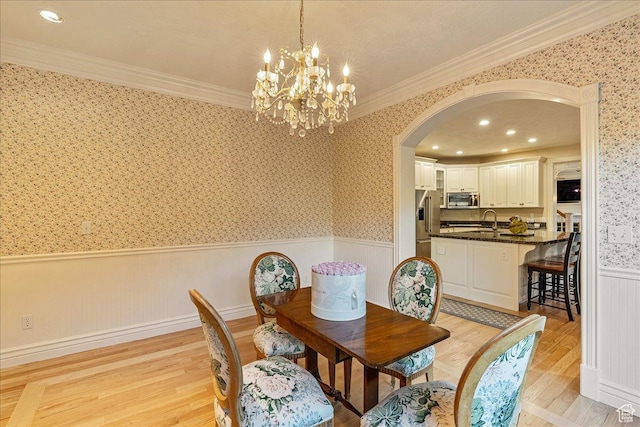 14 N 1025 E, Lindon, UT 84042 - dining area with a wainscoted wall, arched walkways, light wood-style flooring, wallpapered walls, and a chandelier