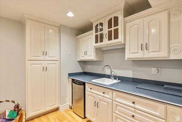 14 N 1025 E, Lindon, UT 84042 - kitchen with a sink, dark countertops, stainless steel dishwasher, light wood-style flooring, and glass insert cabinets