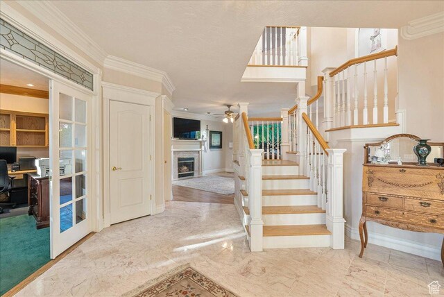 14 N 1025 E, Lindon, UT 84042 - staircase with a ceiling fan, a fireplace, crown molding, marble finish flooring, and baseboards