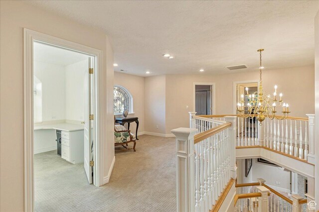14 N 1025 E, Lindon, UT 84042 - corridor featuring an upstairs landing, light carpet, a chandelier, baseboards, and a textured ceiling