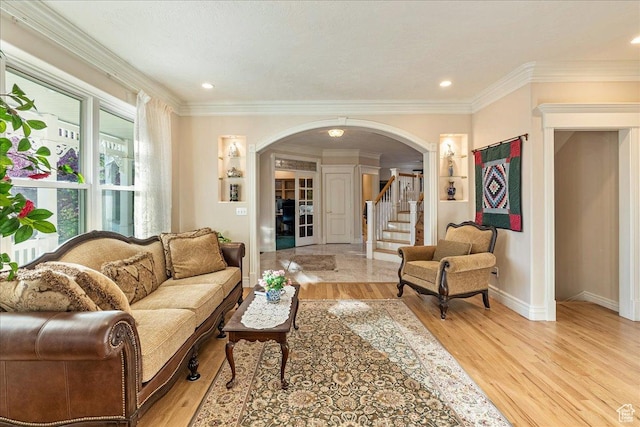 14 N 1025 E, Lindon, UT 84042 - living room featuring arched walkways, light wood finished floors, crown molding, baseboards, and stairway