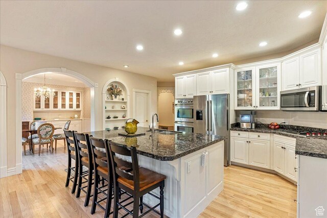 14 N 1025 E, Lindon, UT 84042 - kitchen with appliances with stainless steel finishes, a sink, arched walkways, light wood-style flooring, and recessed lighting