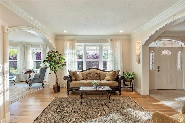 14 N 1025 E, Lindon, UT 84042 - living area featuring arched walkways, plenty of natural light, crown molding, light wood-style flooring, and a textured ceiling
