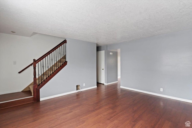 1464 S 1650 E, Ogden, UT 84404 - unfurnished living room with wood finished floors, a textured ceiling, stairway, and baseboards