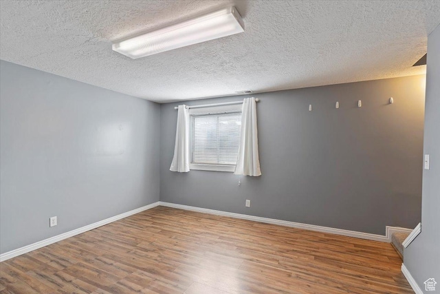 1464 S 1650 E, Ogden, UT 84404 - unfurnished room with wood finished floors, a textured ceiling, and baseboards