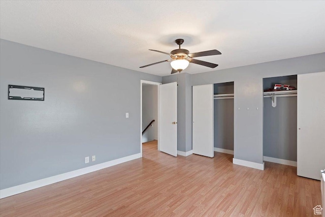 1464 S 1650 E, Ogden, UT 84404 - unfurnished bedroom with two closets, light wood-style floors, baseboards, and a ceiling fan