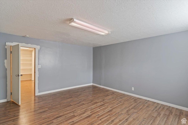1464 S 1650 E, Ogden, UT 84404 - empty room featuring wood finished floors, a textured ceiling, and baseboards