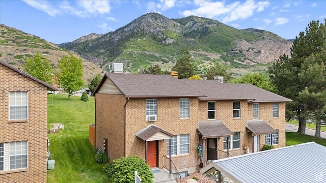 1464 S 1650 E, Ogden, UT 84404 - view of front facade with a mountain view, a front yard, brick siding, and cooling unit