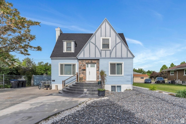 175 N 800 W, Provo, UT 84601 - tudor-style house with a chimney and concrete driveway