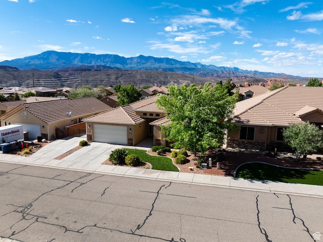 2710 W 410 N, Hurricane, UT 84737 - view of front of house with a garage, concrete driveway, a mountain view, and a tiled roof