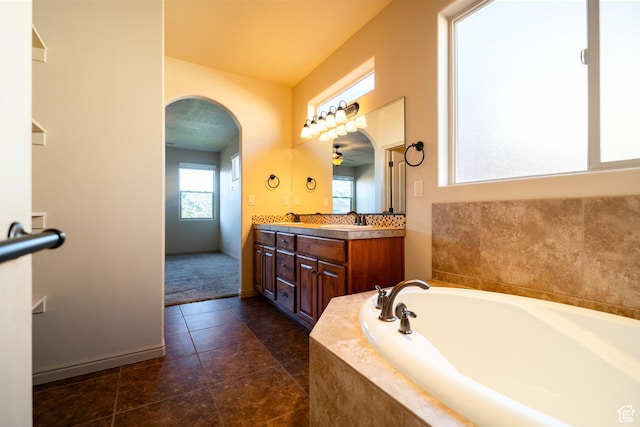 2710 W 410 N, Hurricane, UT 84737 - full bathroom featuring a bath, double vanity, tile patterned flooring, and baseboards