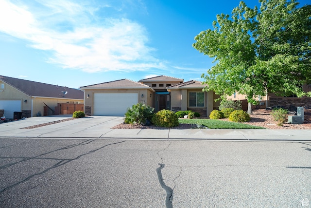 2710 W 410 N, Hurricane, UT 84737 - view of front facade with concrete driveway, an attached garage, and stucco siding